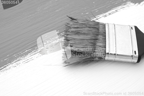 Image of Close-up of paintbrush painting a board
