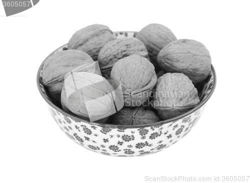 Image of Walnuts in shells, in a china bowl