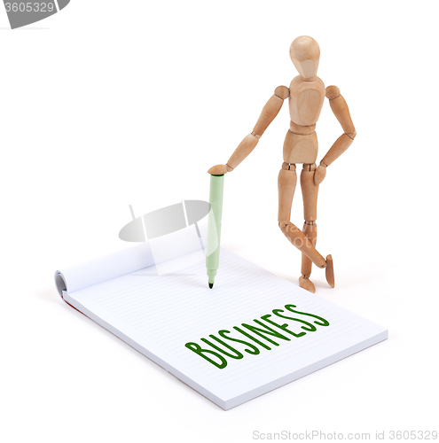 Image of Wooden mannequin writing - Business