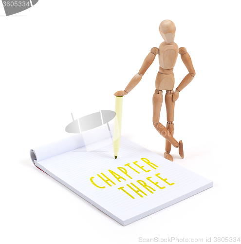 Image of Wooden mannequin writing - Chapter three
