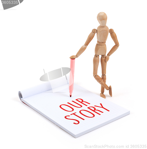 Image of Wooden mannequin writing - our story