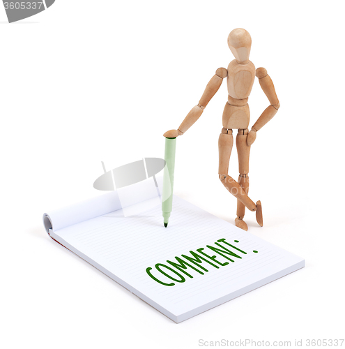 Image of Wooden mannequin writing - Comment