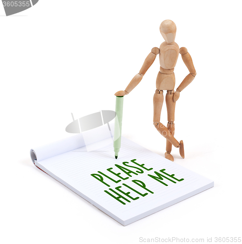 Image of Wooden mannequin writing - Please help me