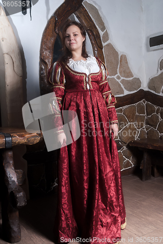 Image of Attractive woman in red dress in retro baroque style