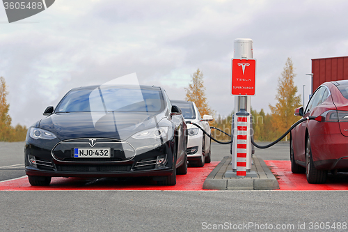 Image of Tesla Model S Cars Plugged In at Supercharger Station