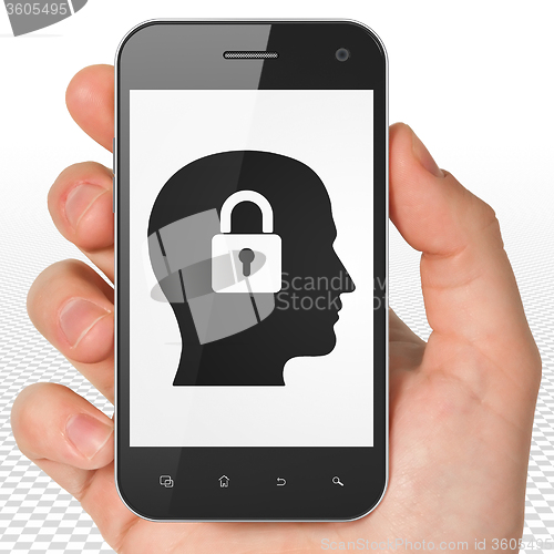 Image of Information concept: Hand Holding Smartphone with Head With Padlock on display