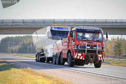 Image of Tank Truck Being Towed by a Heavy Duty Tow Truck