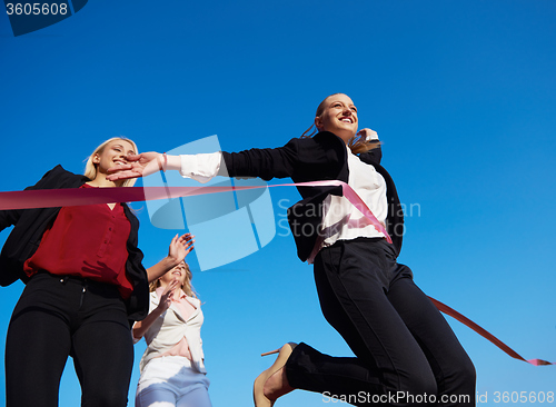 Image of business people running on racing track