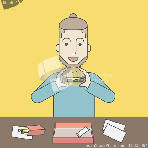 Image of Man eating hamburger. 