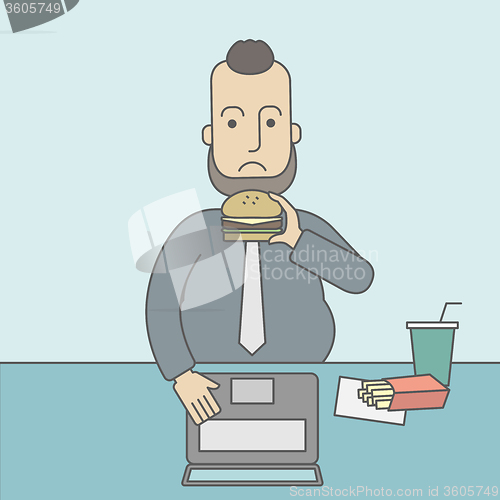 Image of Man eating hamburger. 