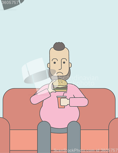 Image of Man eating hamburger. 