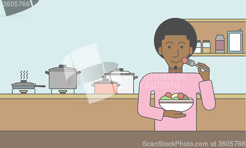 Image of Man eating salad.