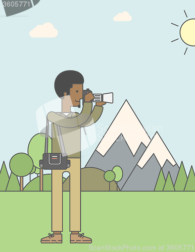 Image of Photographer taking photo in mountains