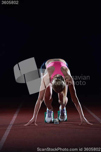 Image of pixelated design of woman  sprinter leaving starting blocks