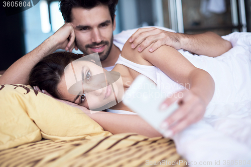 Image of couple relax and have fun in bed