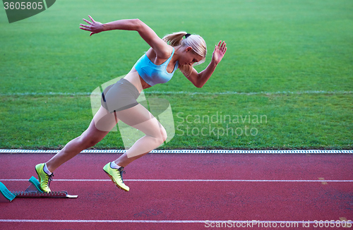 Image of pixelated design of woman  sprinter leaving starting blocks