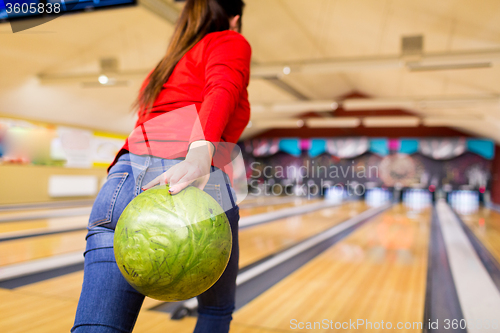 Image of close up of woman throwing ball in bowling club