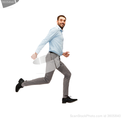 Image of smiling young man running away