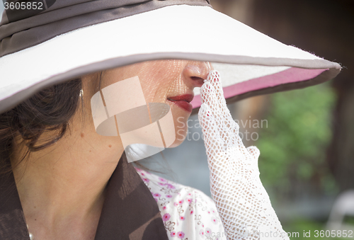 Image of Pretty 1920s Era Dressed Girl With Hat and Gloves