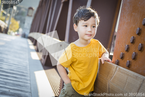 Image of Mixed Race Boy Leaning on Bridge Outdoors