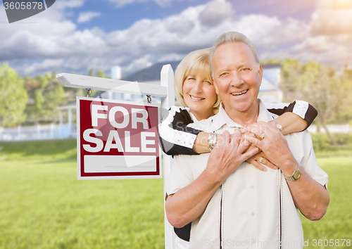 Image of Happy Senior Couple Front of For Sale Sign and House