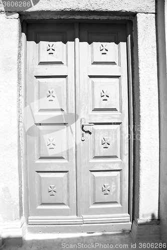 Image of white  red brown  door in antique village santorini greece europ