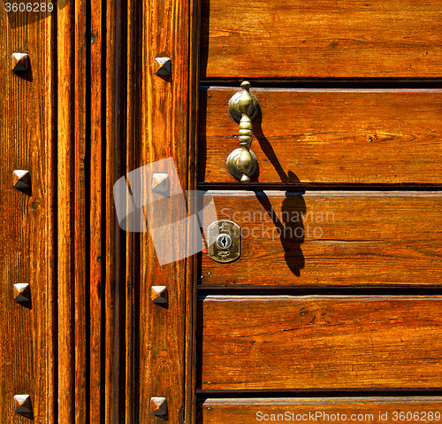 Image of  knocker in a   closed wood door olgiate olona varese italy