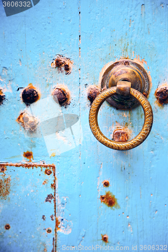 Image of rusty metal   nail dirty  and morocco knocker