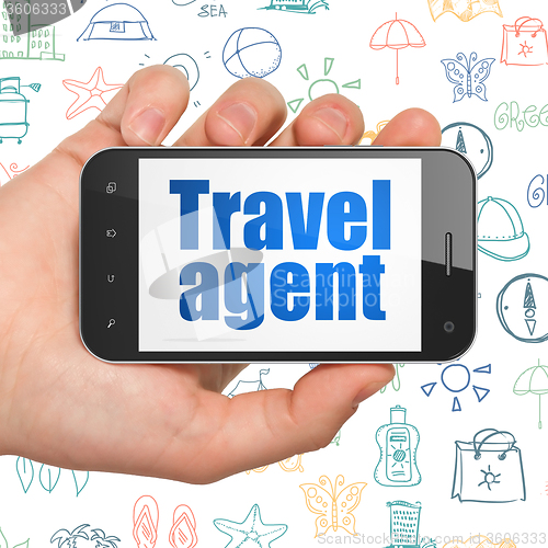 Image of Tourism concept: Hand Holding Smartphone with Travel Agent on display