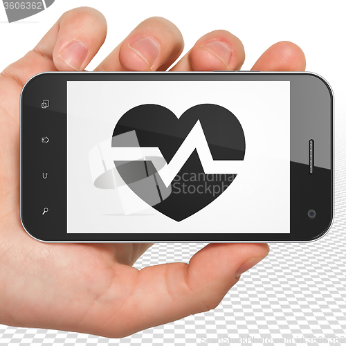 Image of Health concept: Hand Holding Smartphone with Heart on display