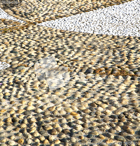 Image of near parabiago street   italy      pavement of a curch and wall 