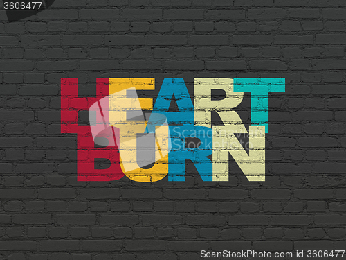 Image of Health concept: Heartburn on wall background