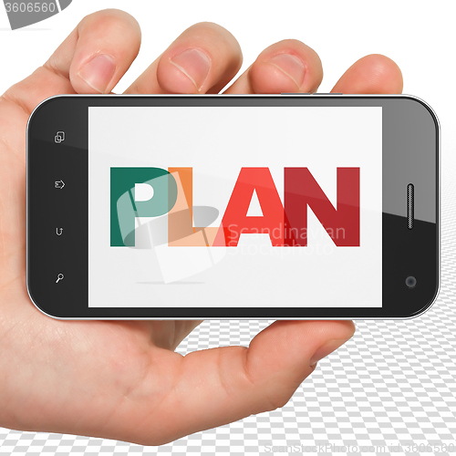 Image of Business concept: Hand Holding Smartphone with Plan on  display