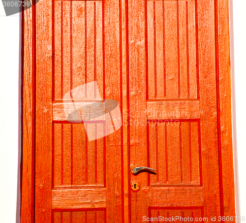 Image of white  red brown  door in antique village santorini greece europ