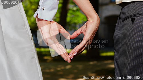 Image of hands bride and groom in shape of heart