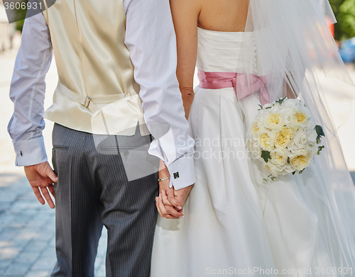 Image of Elegant bride and groom posing together 