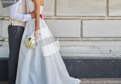 Image of Elegant bride and groom posing together 