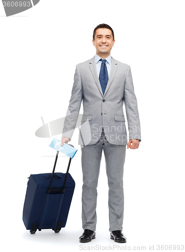 Image of happy businessman in suit with travel bag