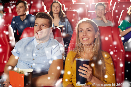 Image of happy couple with popcorn and drink in cinema