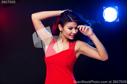 Image of beautiful sexy woman in red dancing at nightclub