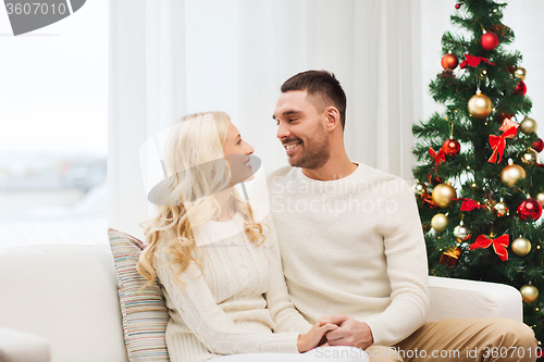 Image of happy couple at home with christmas tree