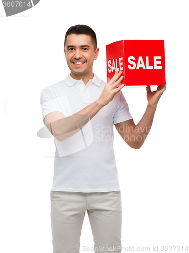 Image of smiling man with red sale sigh