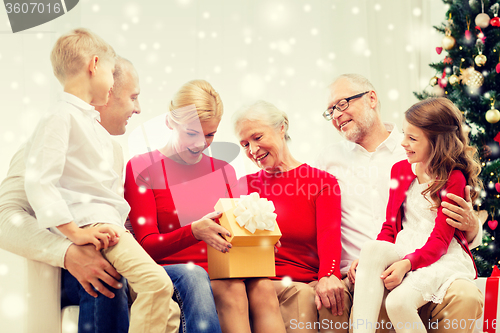 Image of smiling family with gifts at home