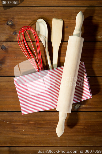 Image of close up of kitchenware for baking on wooden board