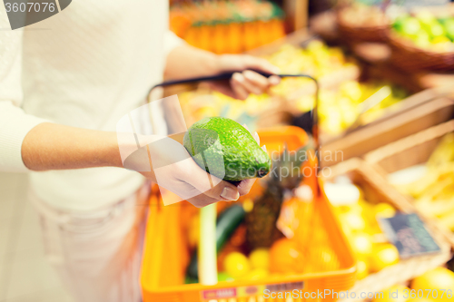 Image of close up of woman with food basket in market