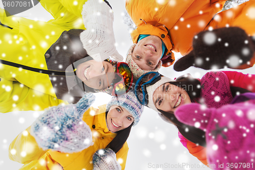 Image of happy friends in winter clothes outdoors