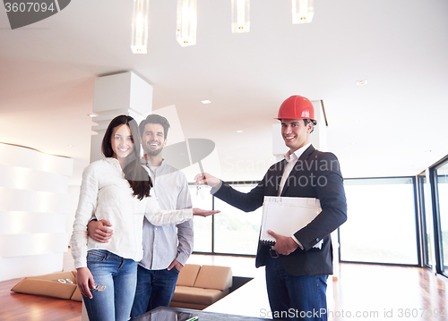 Image of couple buying new home with real estate agent