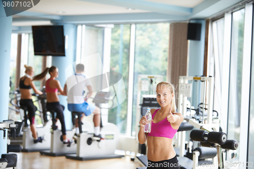 Image of woman in fitness gym drink water