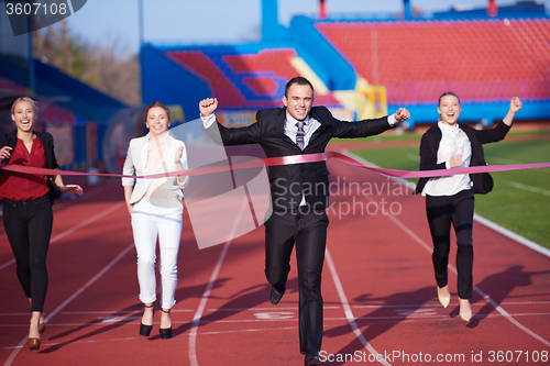 Image of business people running on racing track