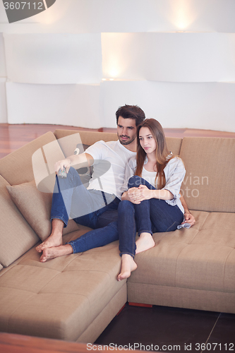Image of young couple watching tv at home